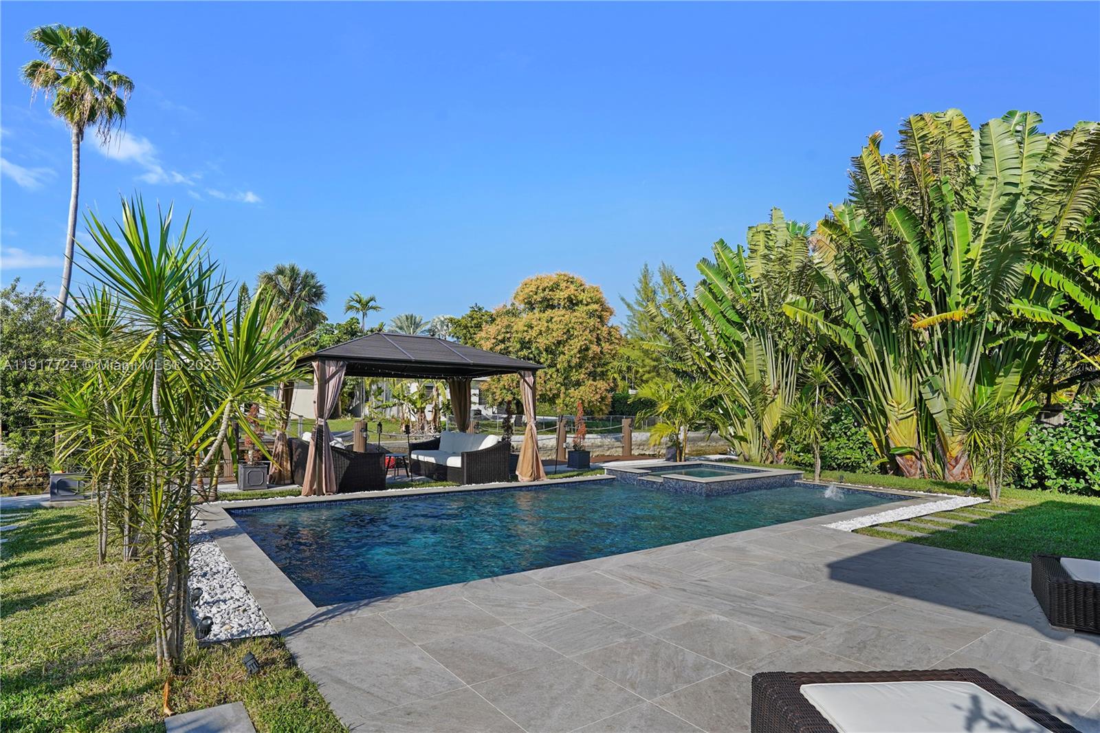 1625 Daytonia Road Miami Beach, FL 33141 - Photo 26 of 39 a view of a yard in front of a house with a large tree