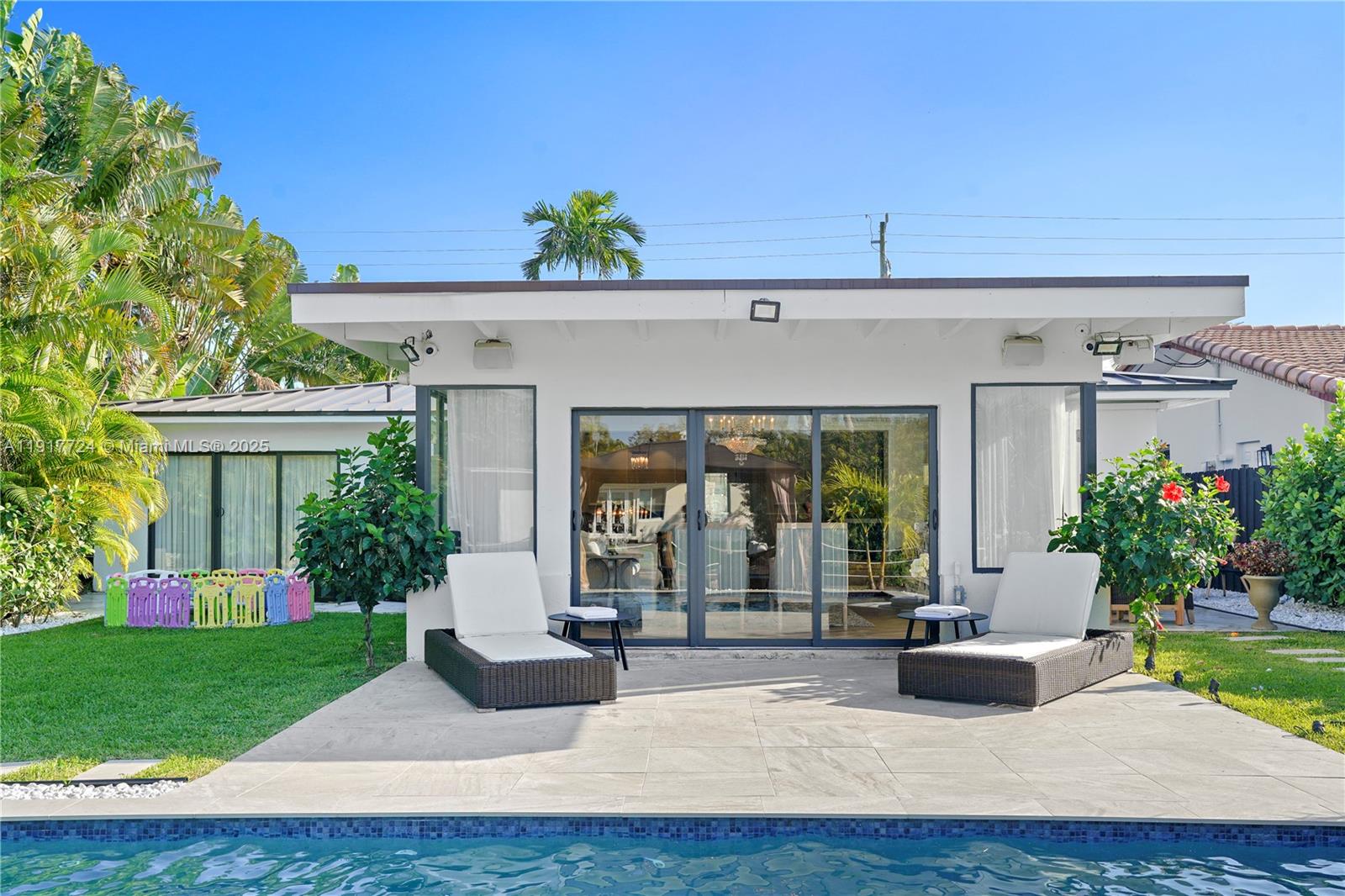 1625 Daytonia Road Miami Beach, FL 33141 - Photo 29 of 39 a view of a house with potted plants and a table