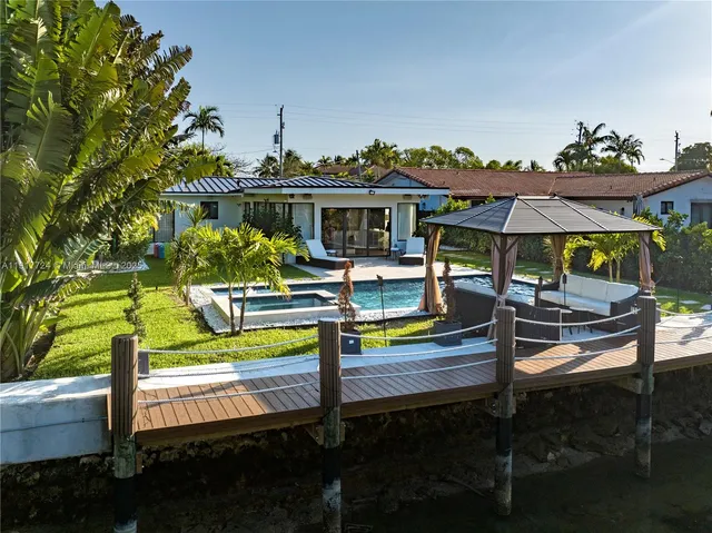 a view of a swimming pool with a patio and a yard