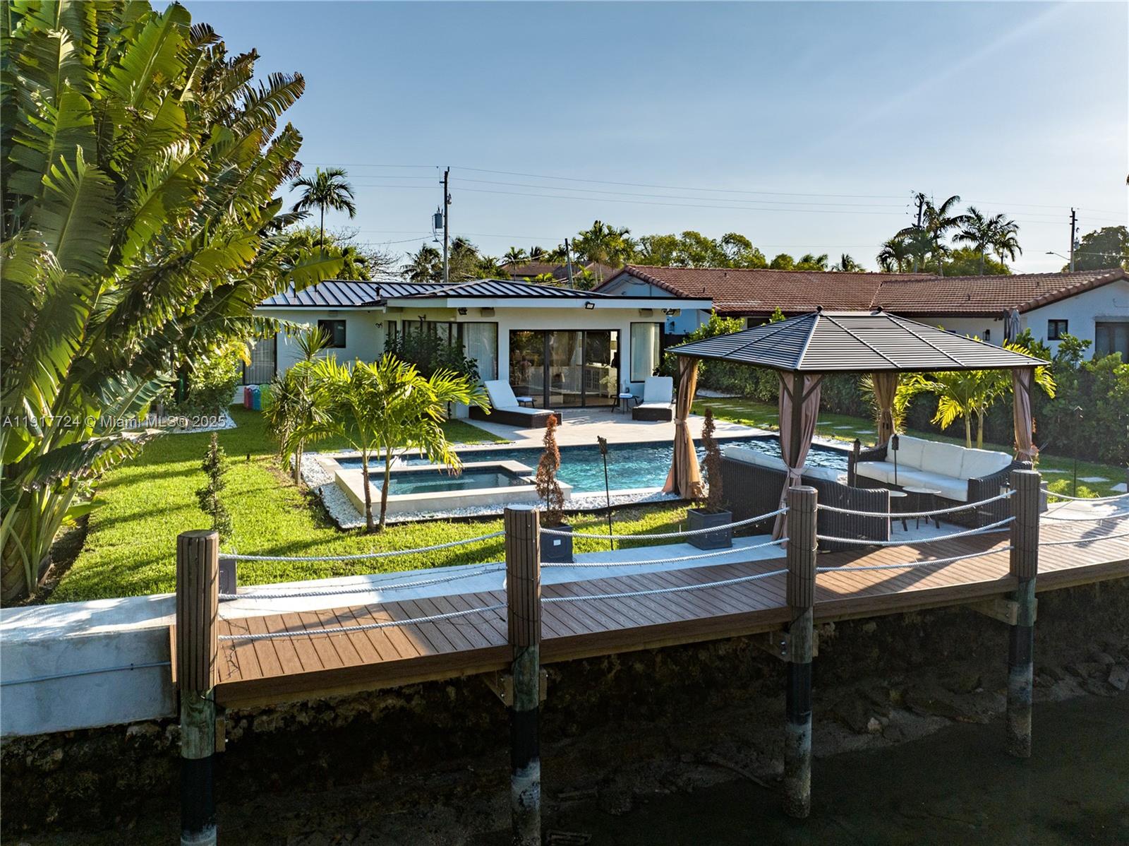 1625 Daytonia Road Miami Beach, FL 33141 - Photo 31 of 39 a view of a swimming pool with a patio and a yard