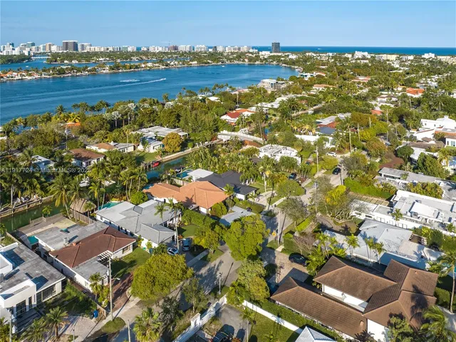 an aerial view of residential building with outdoor space and trees