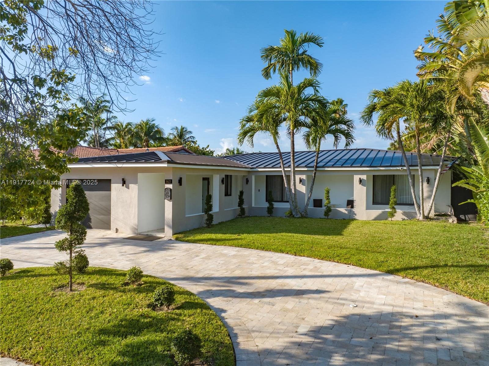 1625 Daytonia Road Miami Beach, FL 33141 - Photo 5 of 39 a view of a house with a swimming pool and a garden