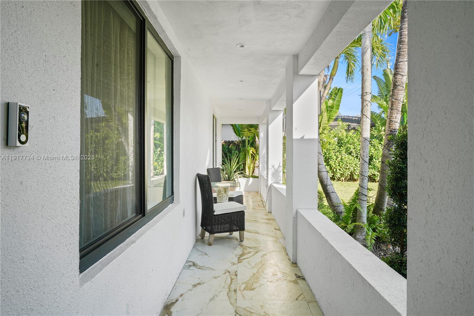 1625 Daytonia Road Miami Beach, FL 33141 - Photo 7 of 39 a living room with large windows and a potted plant