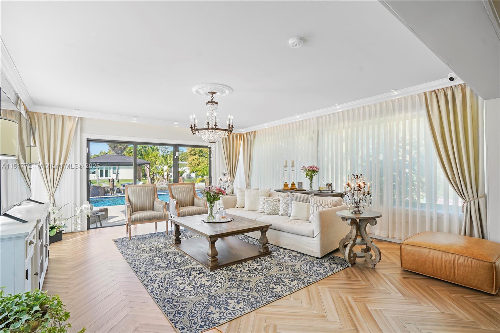 1625 Daytonia Road Miami Beach, FL 33141 - Photo 10 of 39 a living room with furniture and a large window
