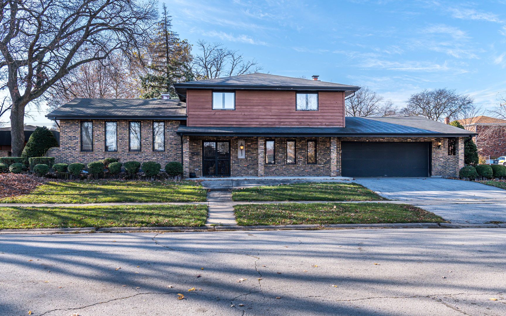 14400 Shepard Drive Dolton, IL 60419 - Photo 2 of 55 a front view of a house with a garden