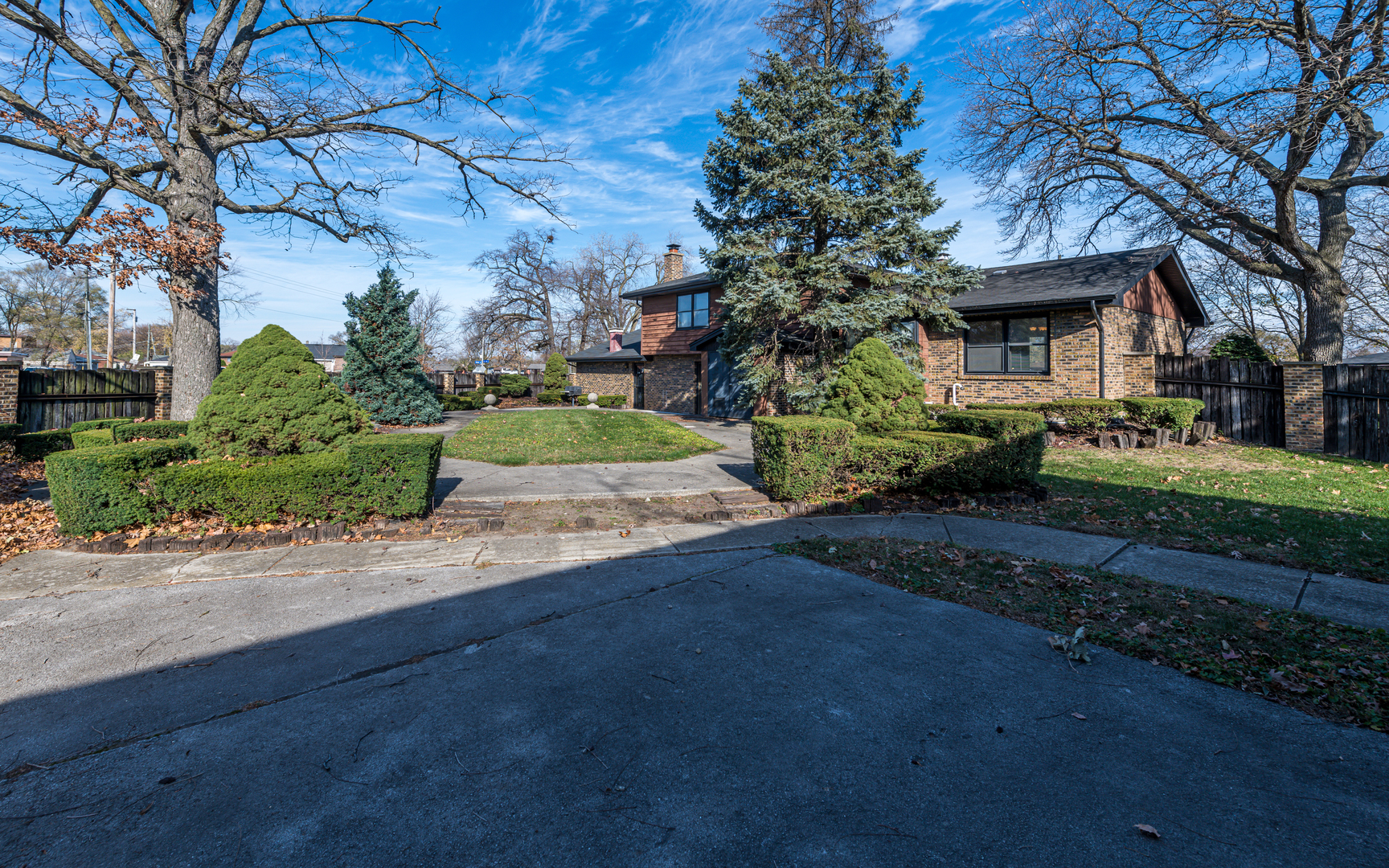 14400 Shepard Drive Dolton, IL 60419 - Photo 3 of 55 a front view of a house with a garden and trees