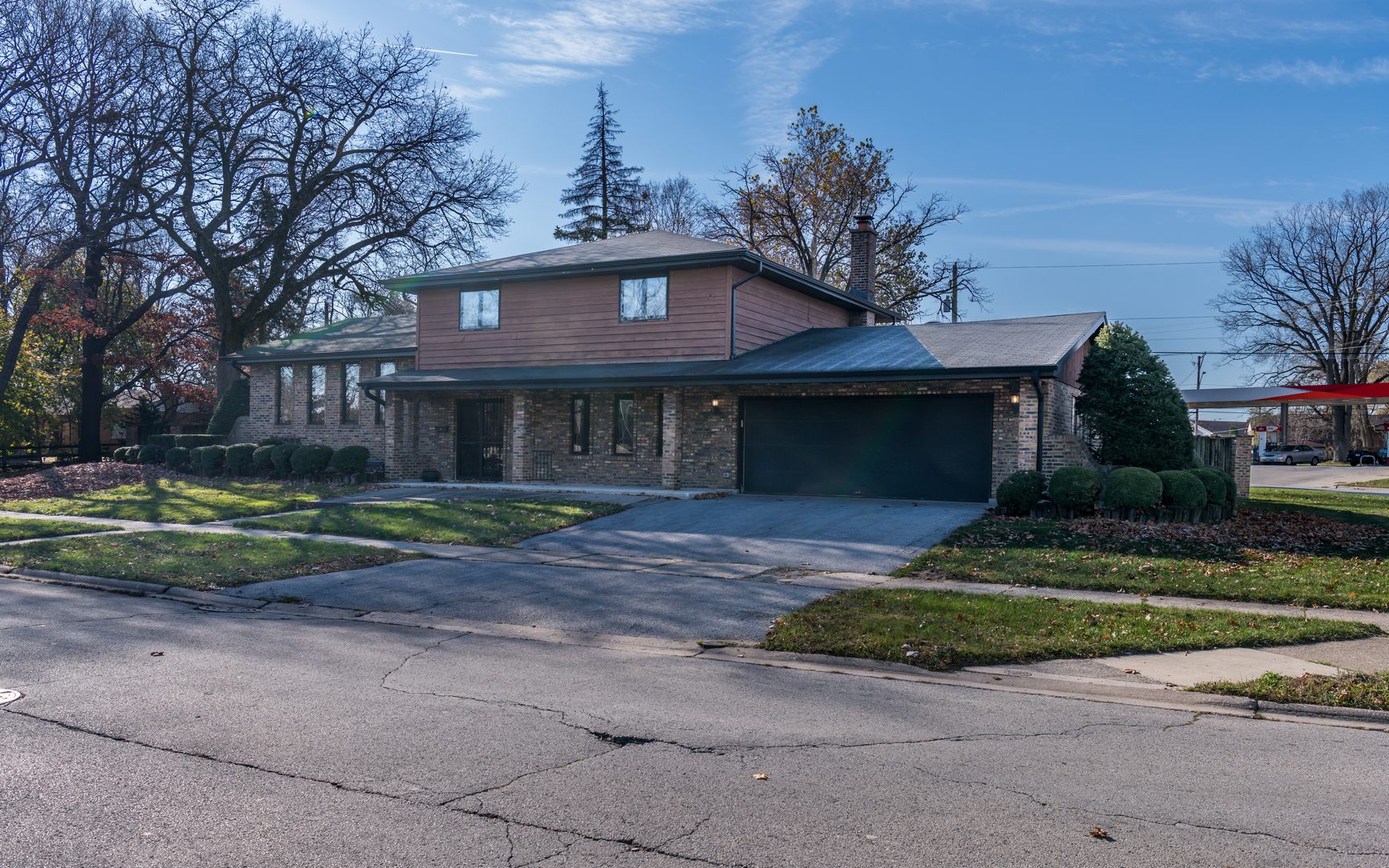 14400 Shepard Drive Dolton, IL 60419 - Photo 4 of 55 a front view of a house with a garden and trees