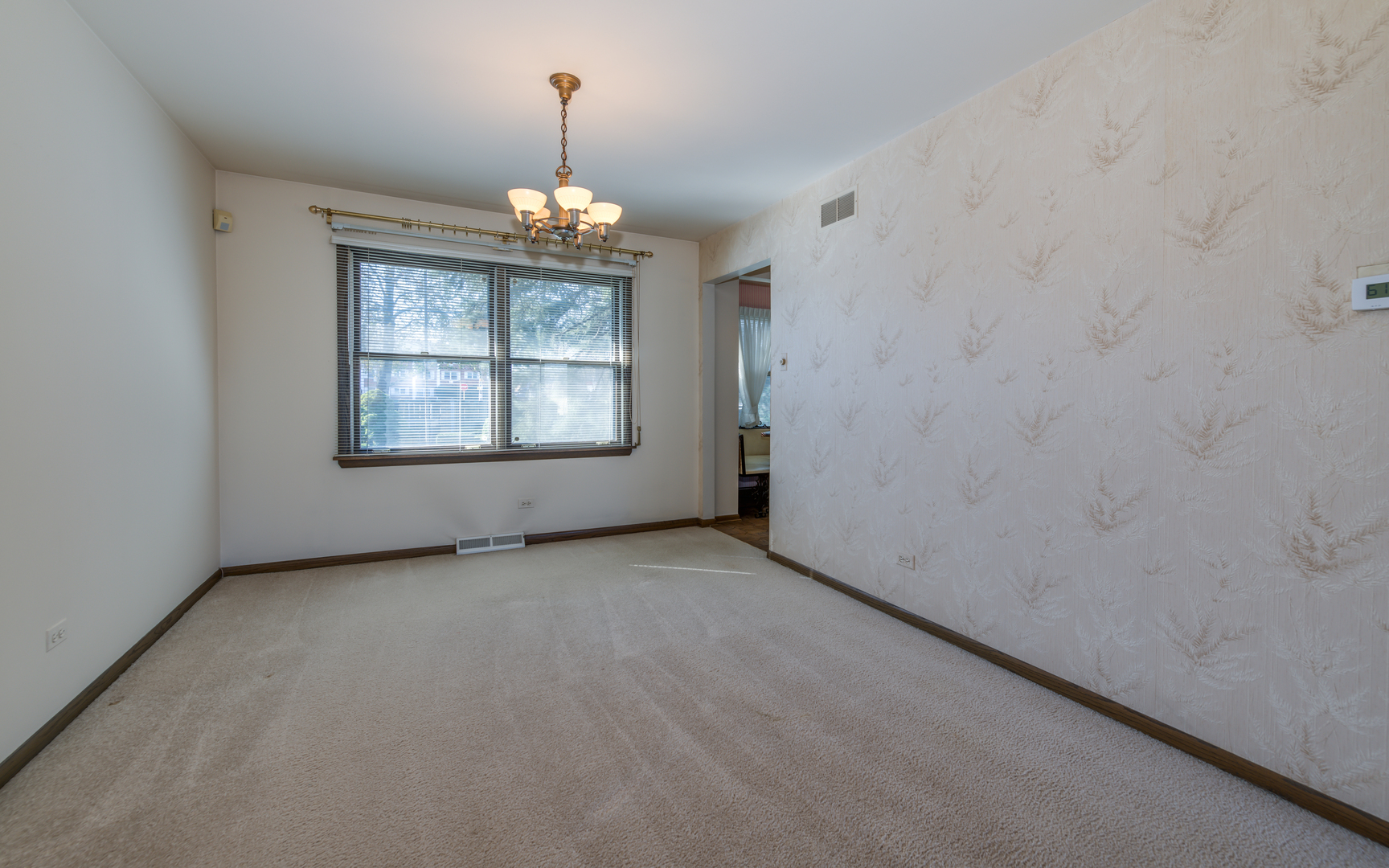 14400 Shepard Drive Dolton, IL 60419 - Photo 9 of 55 en empty room with windows and chandelier