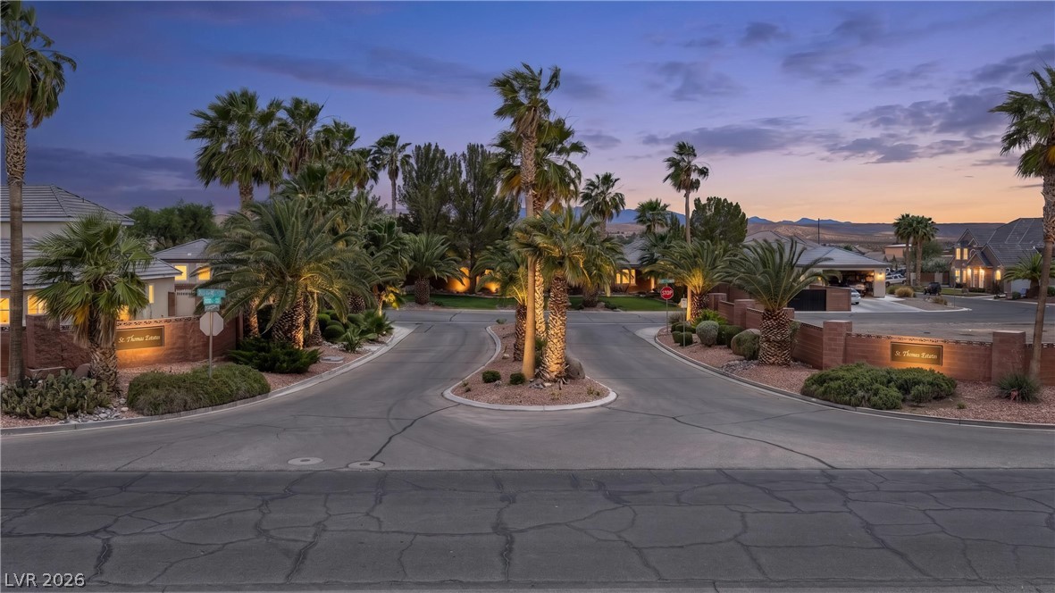 1141 Thomas Bay Circle Logandale, NV 89021 - Photo 7 of 16 This private, gated community entry features mature palm trees and lush landscaping.