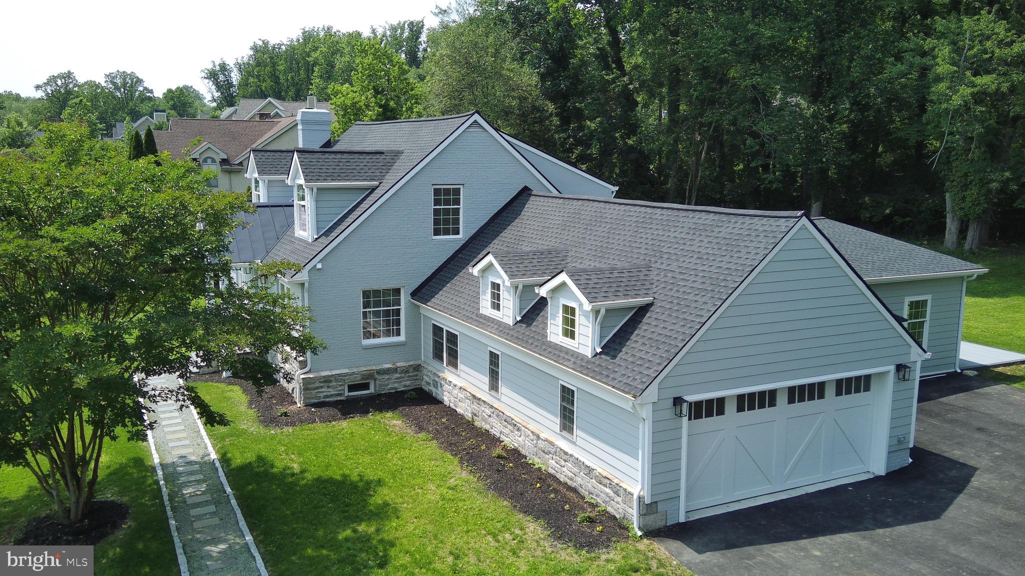 a aerial view of a house with a yard deck and furniture