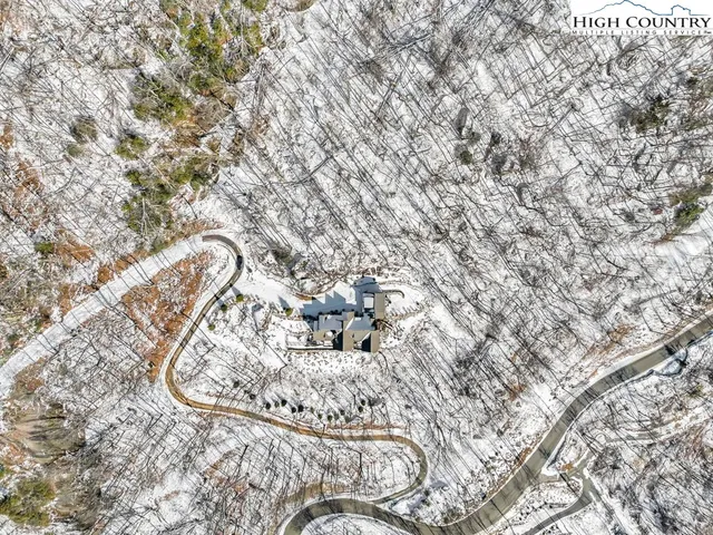 a view of a patio with couches chairs potted plants and city view