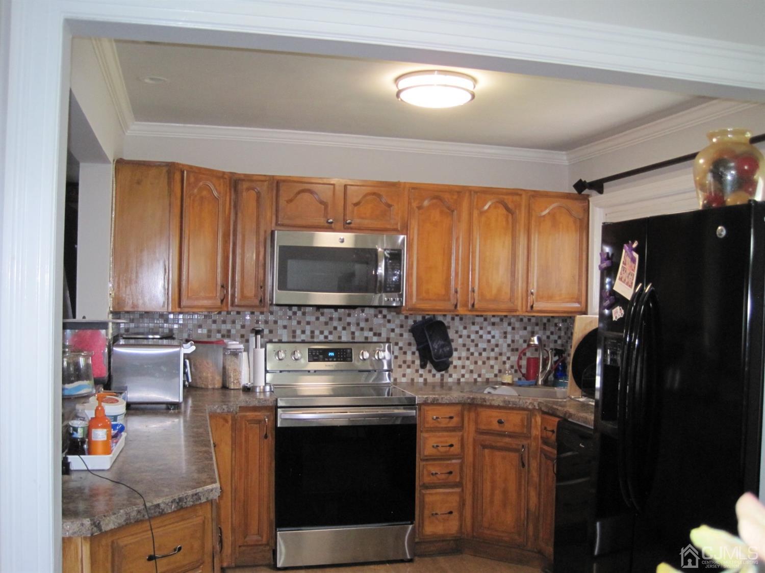 11 Pine Tree Road Old Bridge, NJ 08857 - Photo 2 of 12 a kitchen with stainless steel appliances granite countertop a sink stove and cabinets
