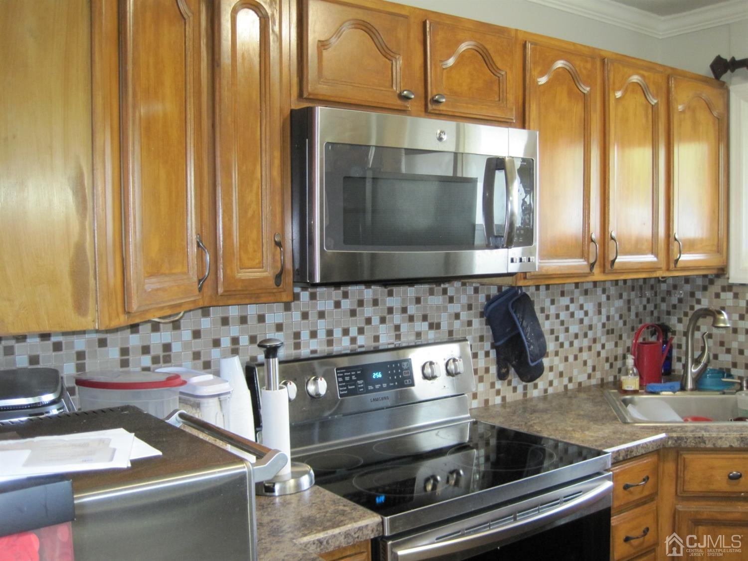 11 Pine Tree Road Old Bridge, NJ 08857 - Photo 3 of 12 a kitchen with stainless steel appliances wooden cabinets and a sink