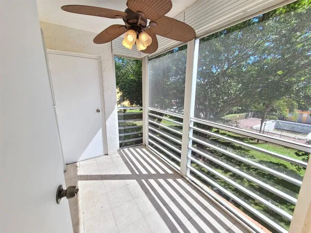 a view of a balcony with furniture and wooden floor