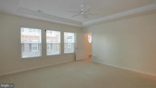 an empty room with a empty space and windows