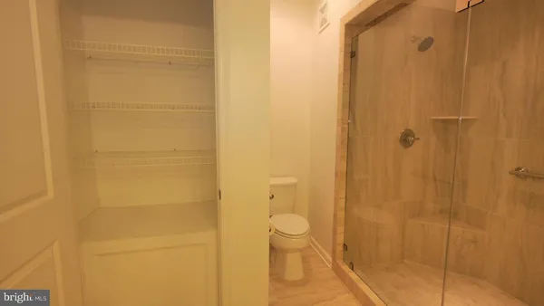 a bathroom with a toilet and shower