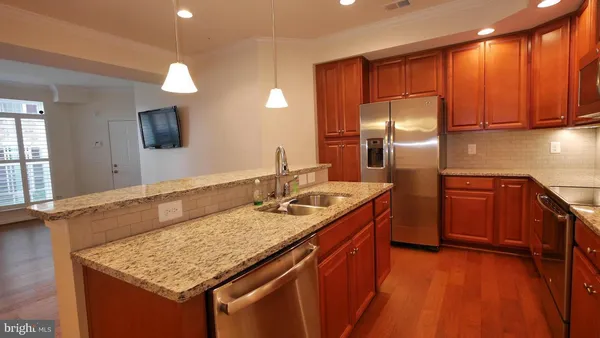 a kitchen with stainless steel appliances granite countertop a sink and a stove