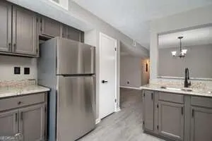 a kitchen with a refrigerator and a sink