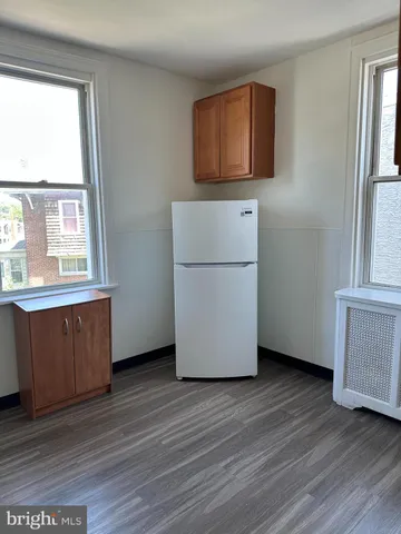 a room with wooden floor and windows