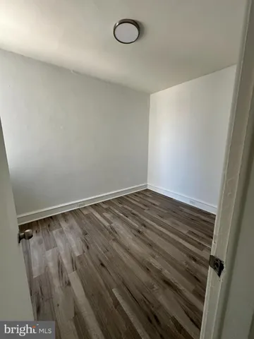 a view of a room with wooden floor and sink