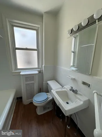 a bathroom with a sink toilet and a mirror