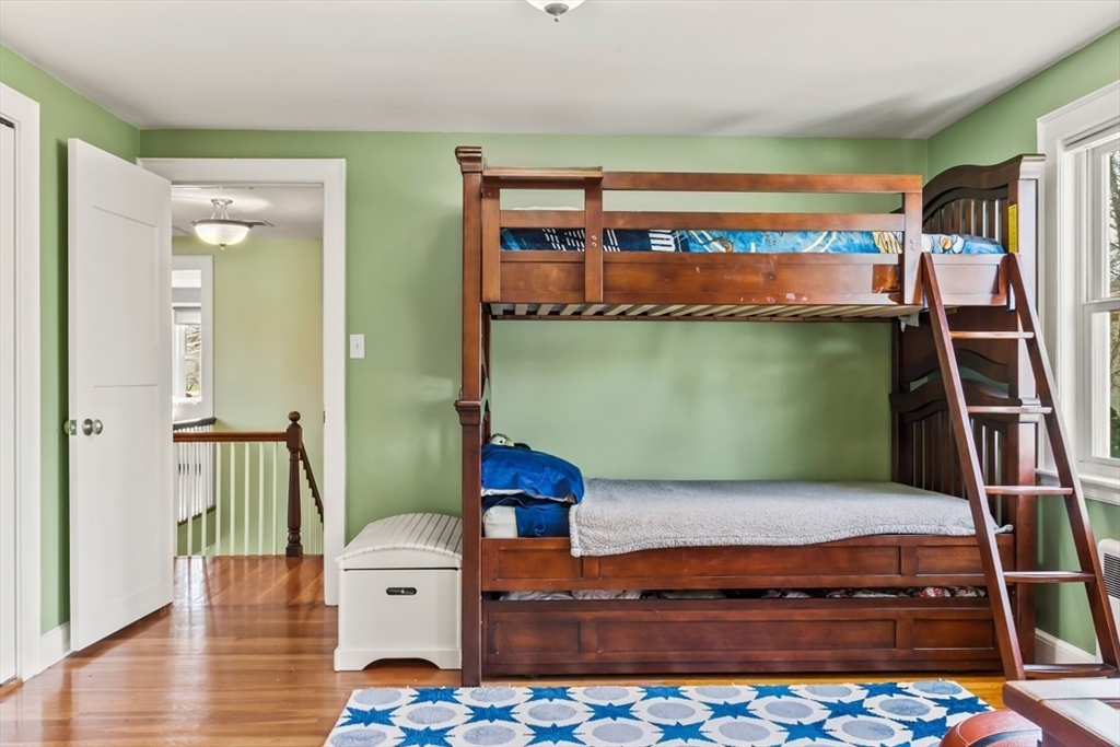 55 Wheeler Road Newton, MA 02459 - Photo 16 of 22 a living room with a rug and a wooden floor