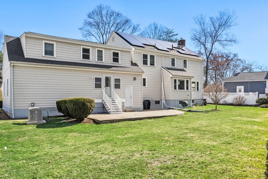 55 Wheeler Road Newton, MA 02459 - Photo 22 of 22 a front view of a house with a yard and garage