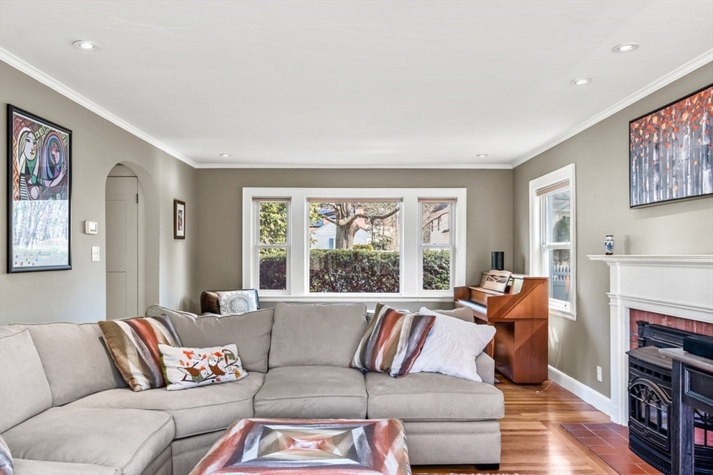 55 Wheeler Road Newton, MA 02459 - Photo 10 of 22 a living room with furniture fireplace and a large window