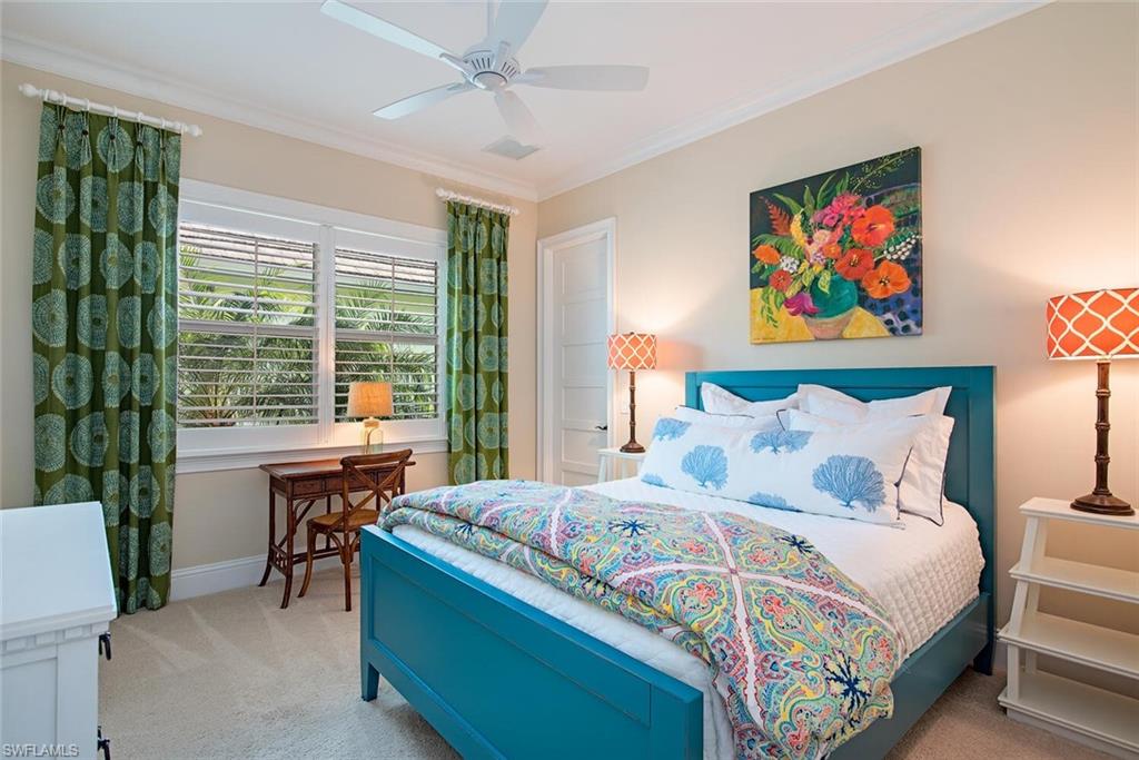 5098 Andros Drive Naples, FL 34113 - Photo 15 of 22 a bedroom with a bed and a table