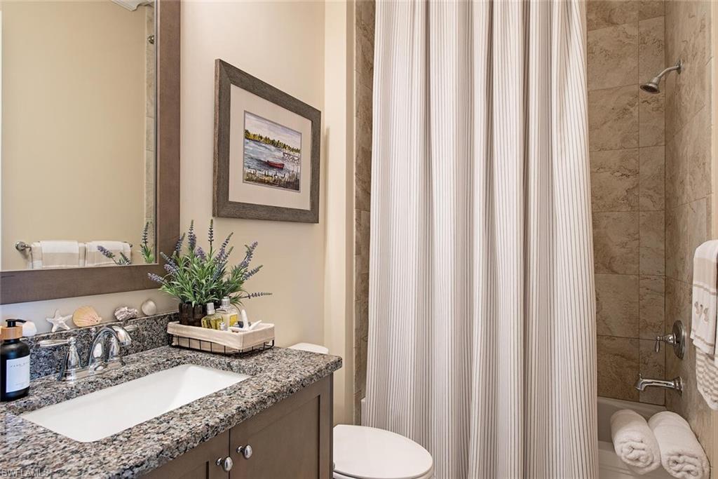 5098 Andros Drive Naples, FL 34113 - Photo 16 of 22 a bathroom with a granite countertop sink and a mirror
