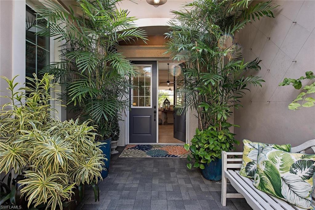 5098 Andros Drive Naples, FL 34113 - Photo 2 of 22 a front view of a house with a plant