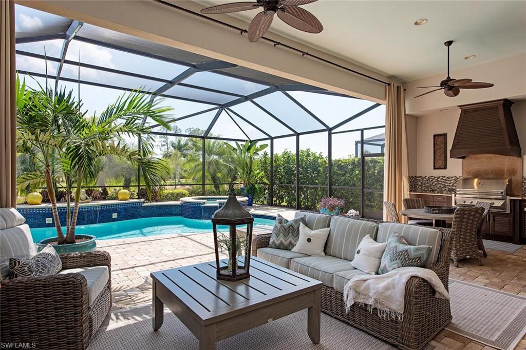 5098 Andros Drive Naples, FL 34113 - Photo 6 of 22 a living room with patio furniture and a floor to ceiling window