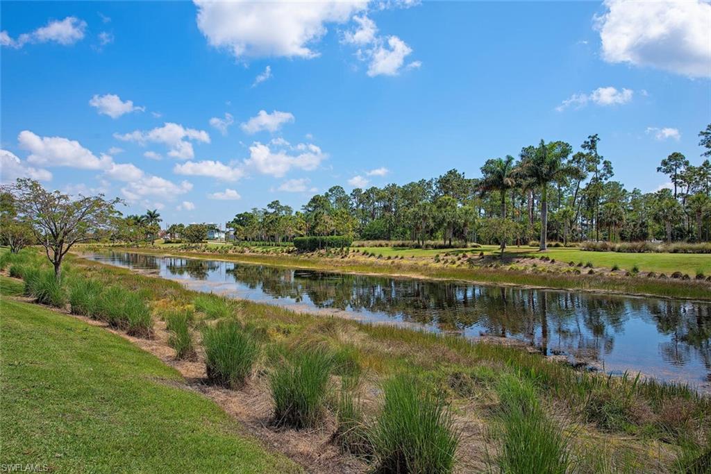 5098 Andros Drive Naples, FL 34113 - Photo 8 of 22 a view of a lake with houses in the back