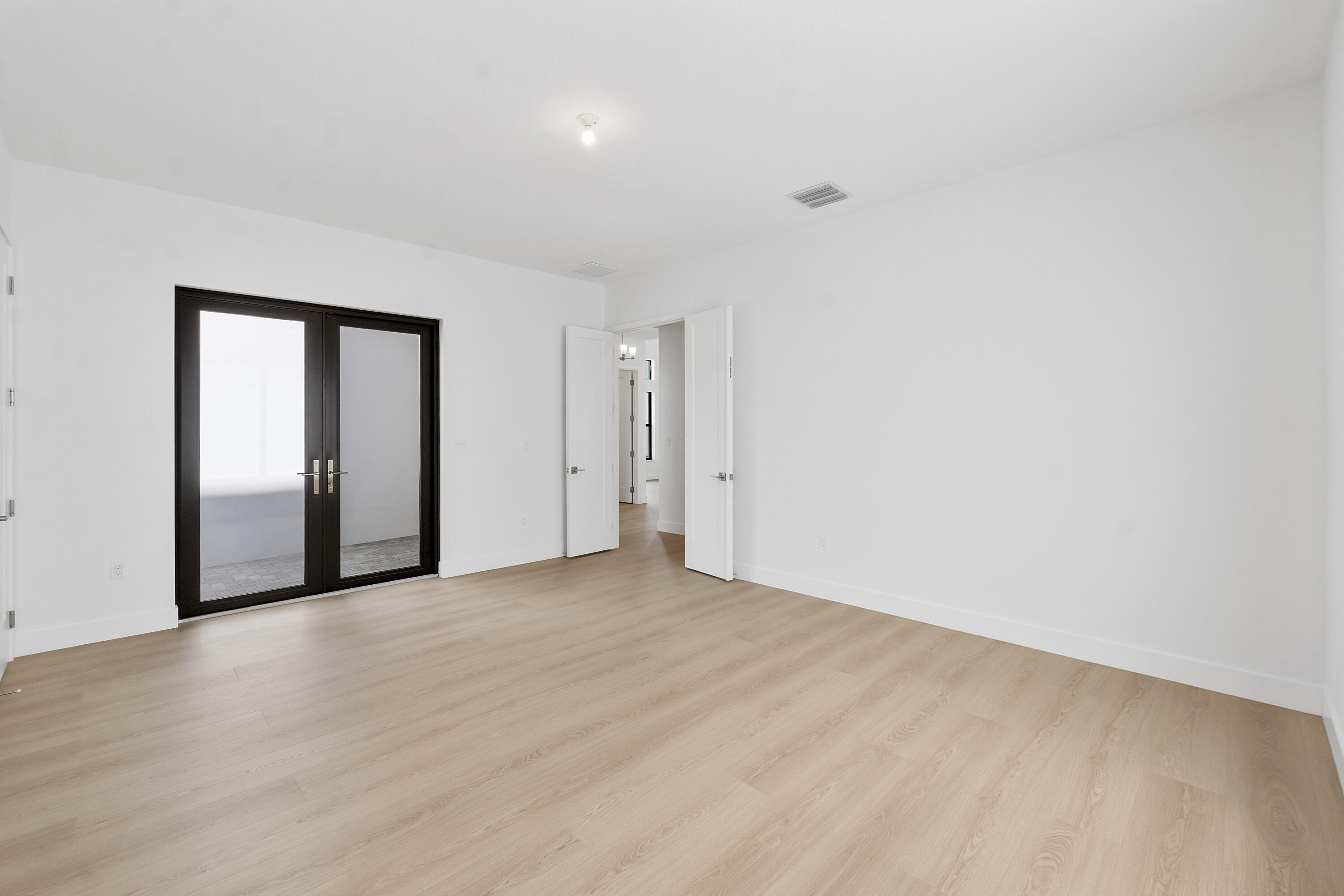 9322 Sunflower Mdw Road Boca Raton, FL 33434 - Photo 25 of 87 a view of an empty room with wooden floor and a window