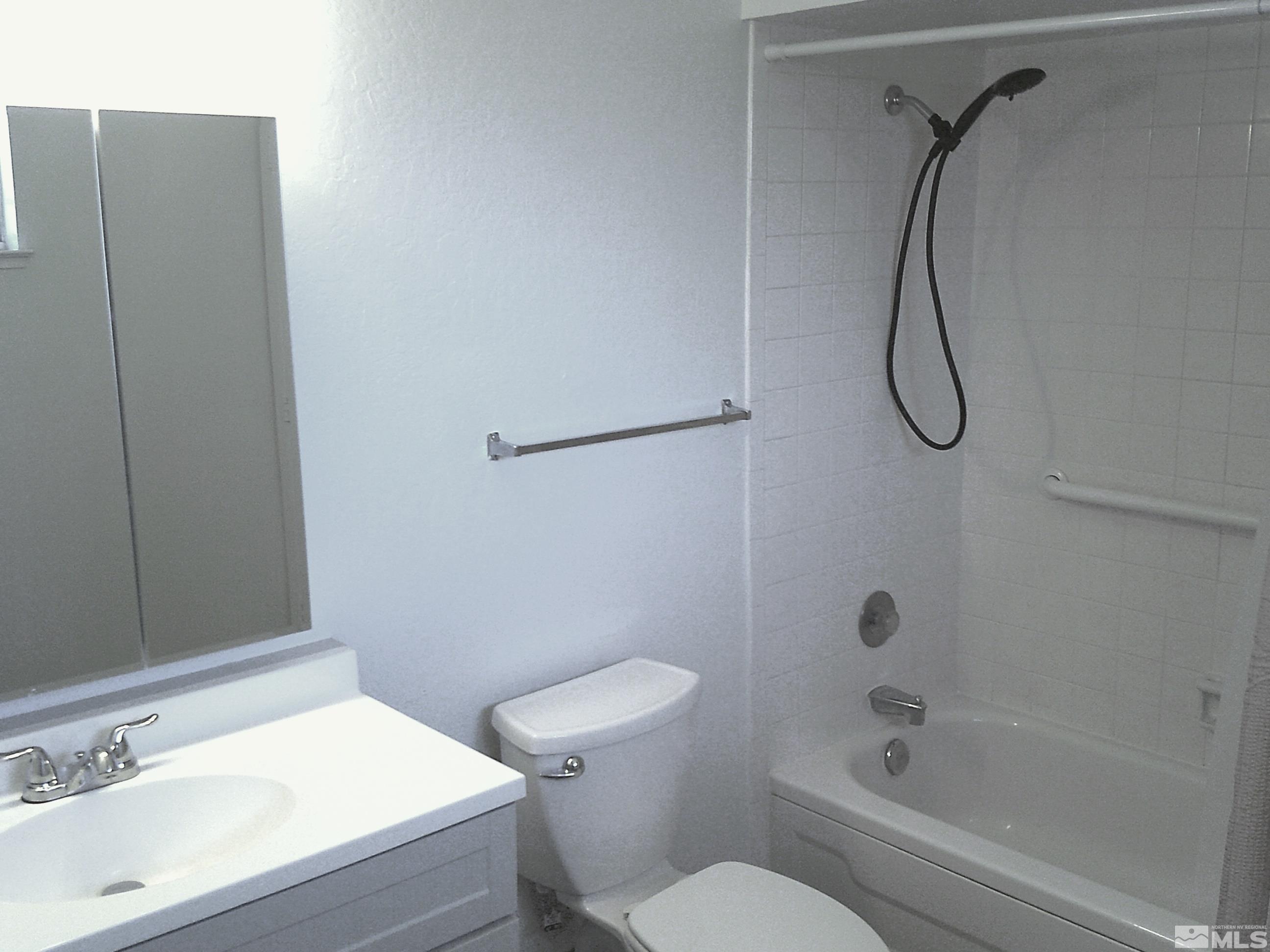 1456 Frontier Street Reno, NV 89503 - Photo 11 of 11 a bathroom with a granite countertop sink toilet and shower