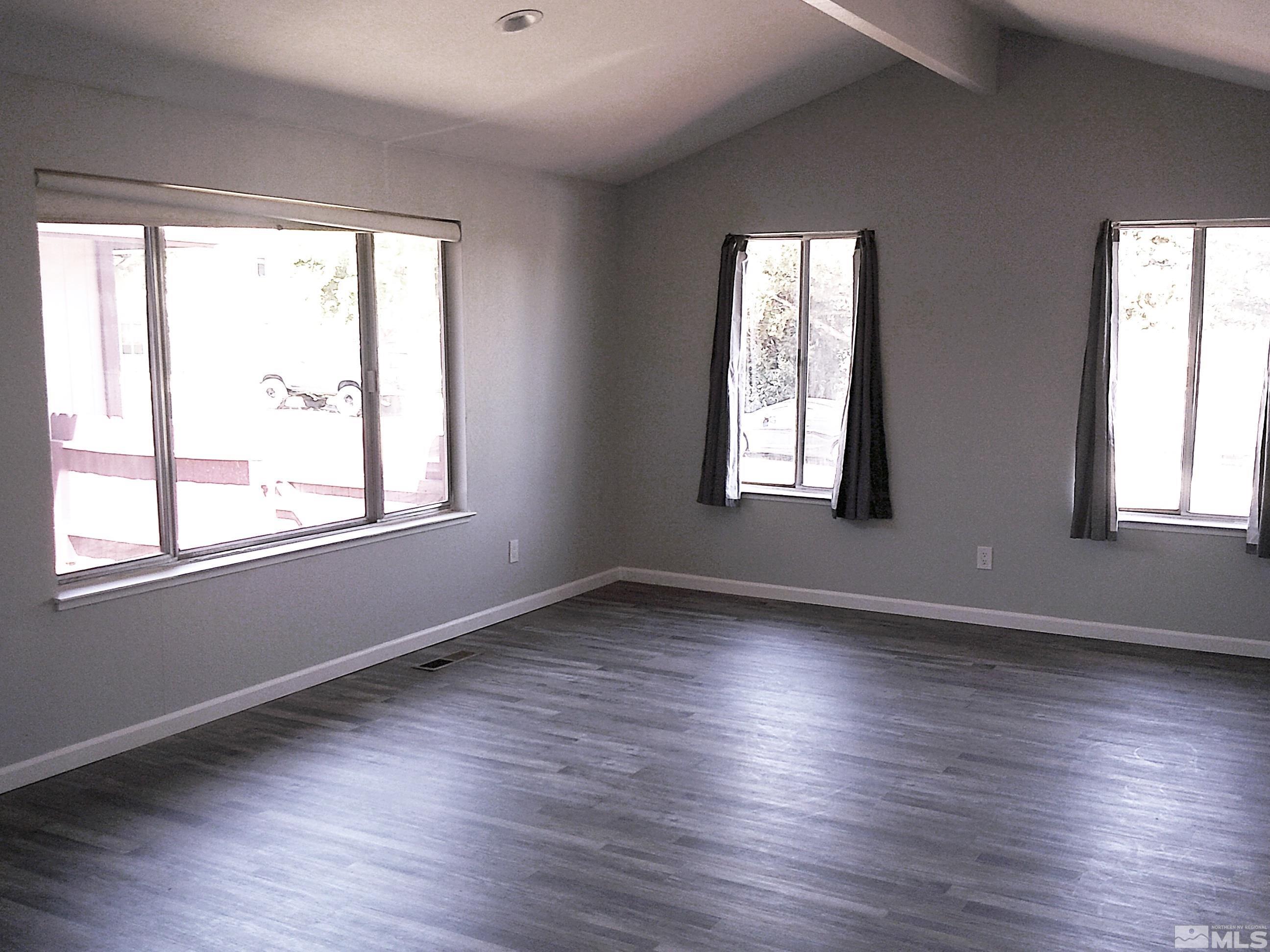 1456 Frontier Street Reno, NV 89503 - Photo 3 of 11 a view of an empty room with wooden floor and a window