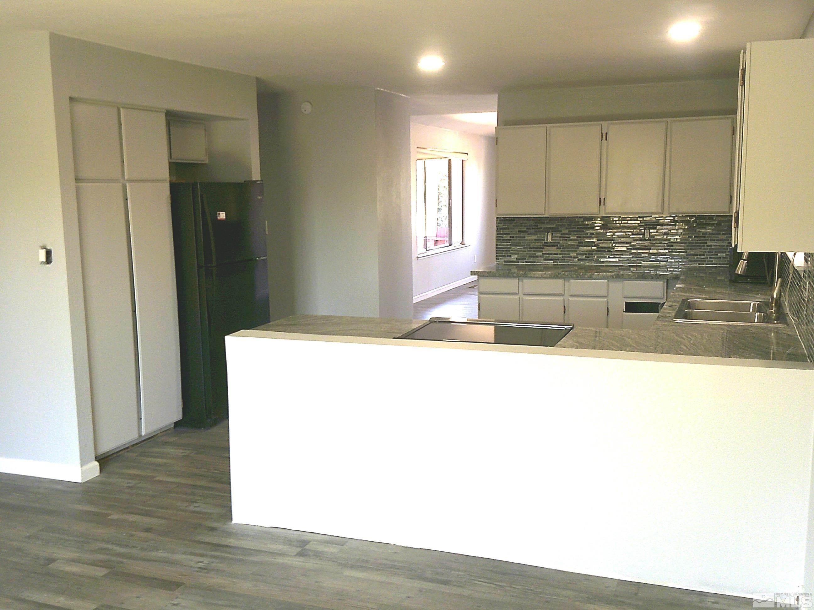 1456 Frontier Street Reno, NV 89503 - Photo 5 of 11 a kitchen with kitchen island sink and refrigerator