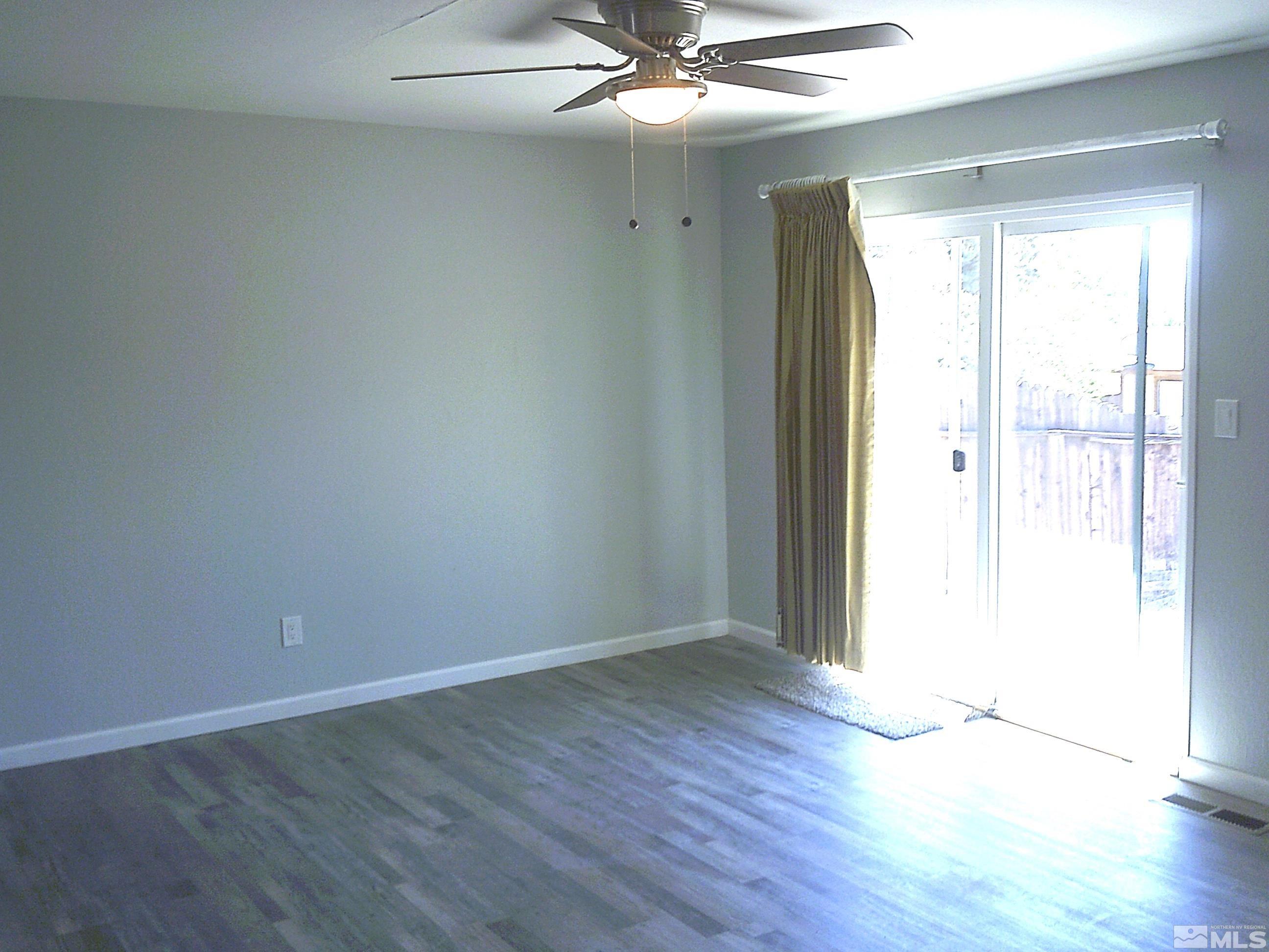 1456 Frontier Street Reno, NV 89503 - Photo 8 of 11 an empty room with wooden floor and windows