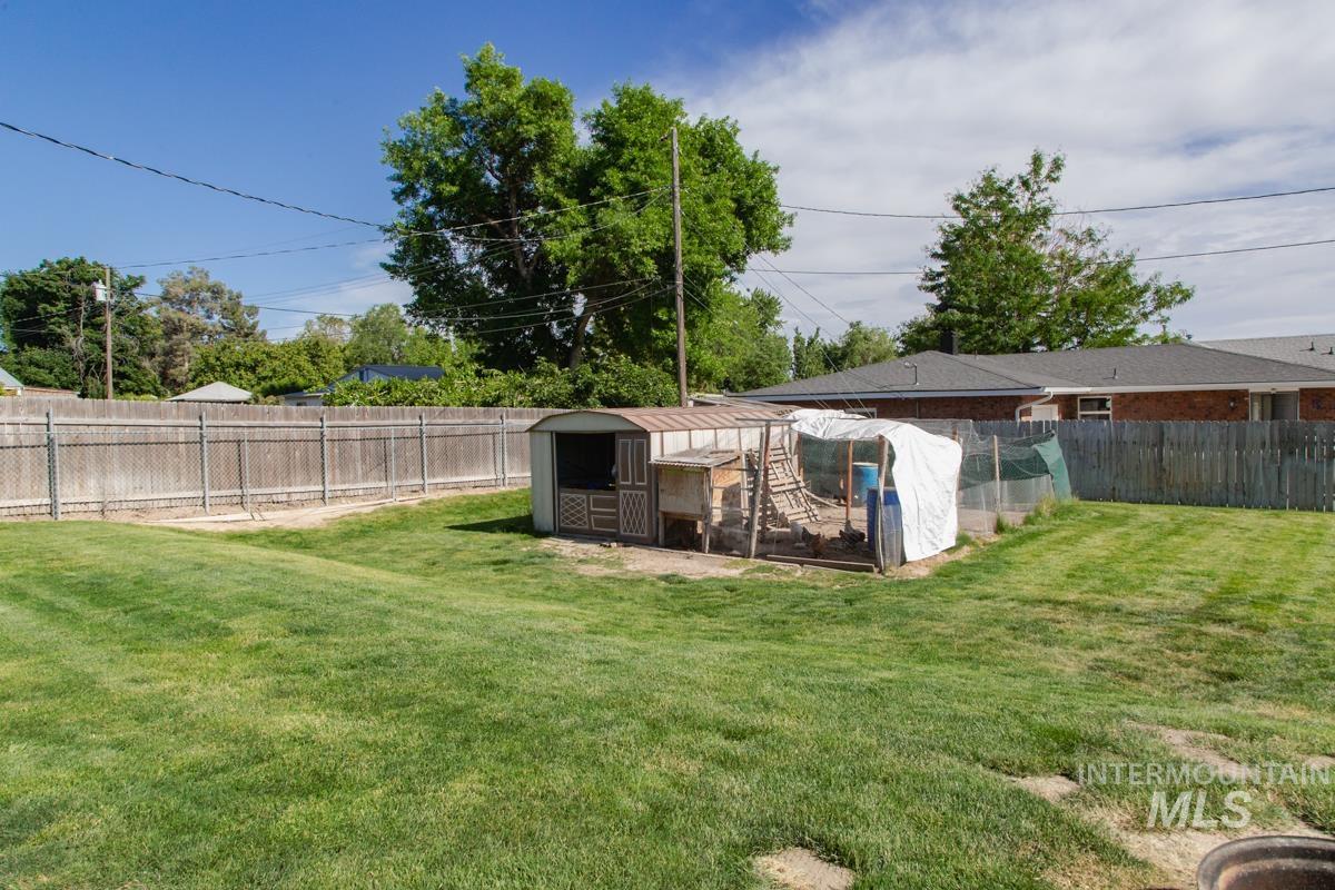 1404 Rochester Street Caldwell, ID 83605 - Photo 26 of 29 Expansive grassy yard area with a storage shed and additional enclosed structures