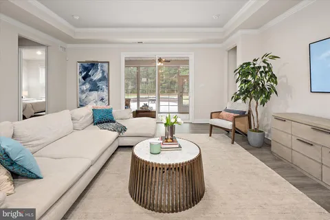 a kitchen with stainless steel appliances granite countertop a dining table chairs refrigerator and microwave