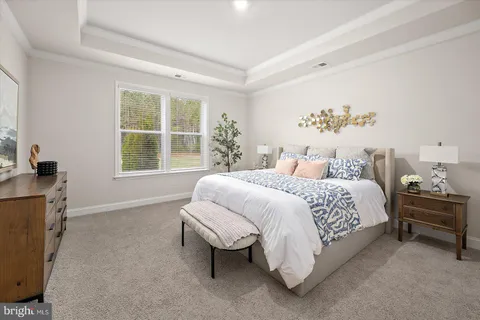 a bedroom with two beds and a potted plant