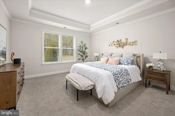 a bedroom with two beds and a potted plant