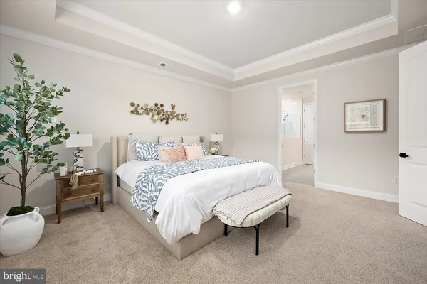 a bedroom with two bed and a painting on the wall