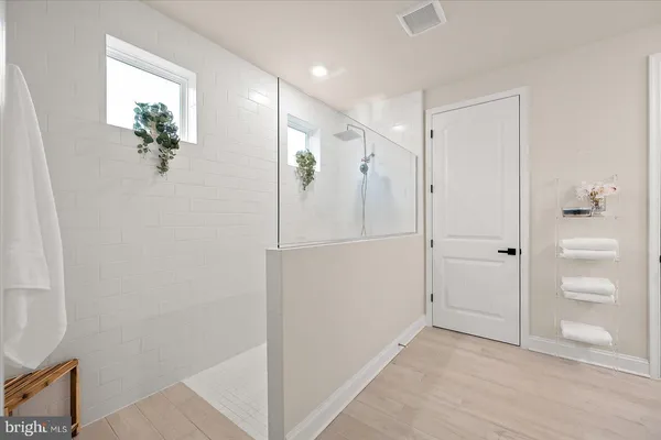 a bathroom with a toilet a sink and a mirror