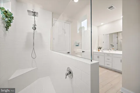 a bedroom with a bed and painting on the wall