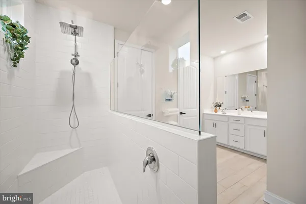 a bedroom with a bed and painting on the wall