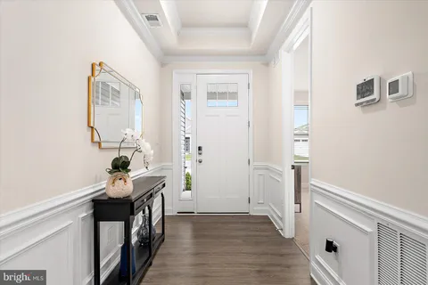 a large kitchen with a lot of counter space and a wooden floor