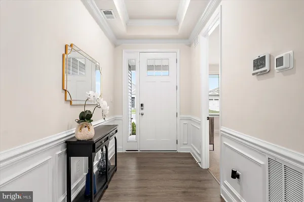 a large kitchen with a lot of counter space and a wooden floor