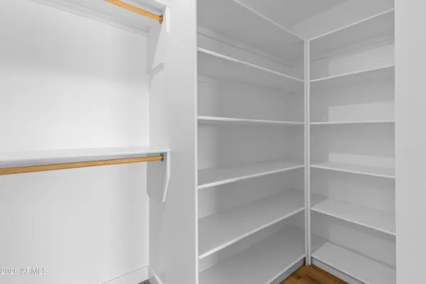 a view of walk in closet with empty racks