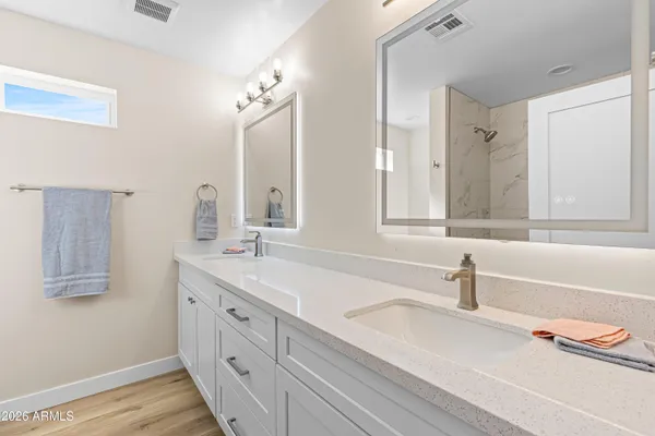 a bathroom with a tub a sink and a mirror